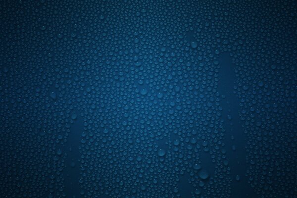 Gocce d acqua sulla superficie blu