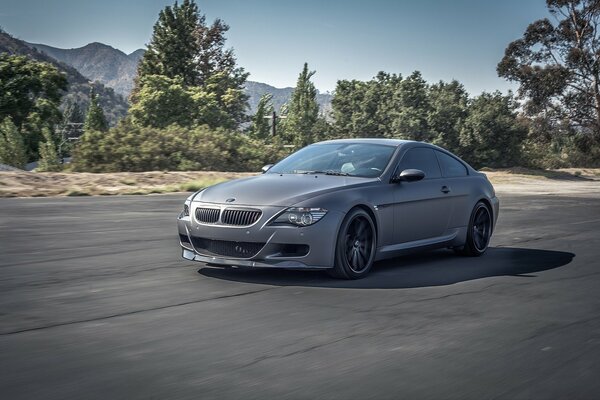 Bmw grigio opaco sullo sfondo delle montagne