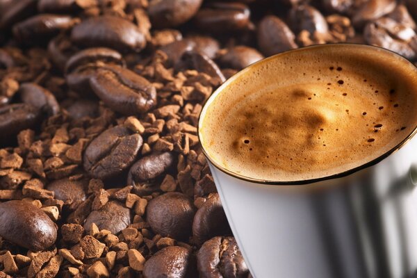 Tazza di caffè con schiuma sui chicchi