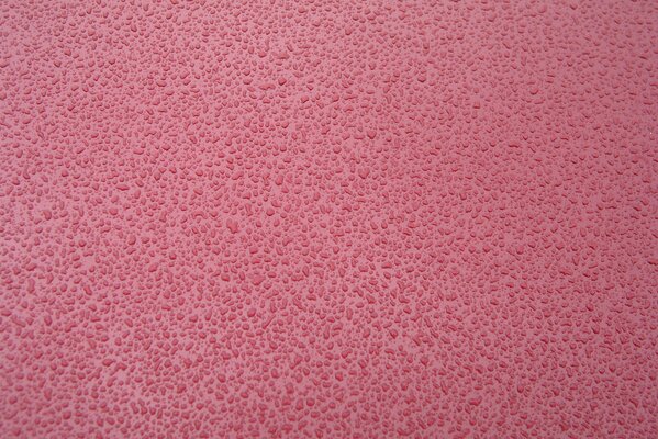Bellissimo sfondo rosa strutturato con gocce