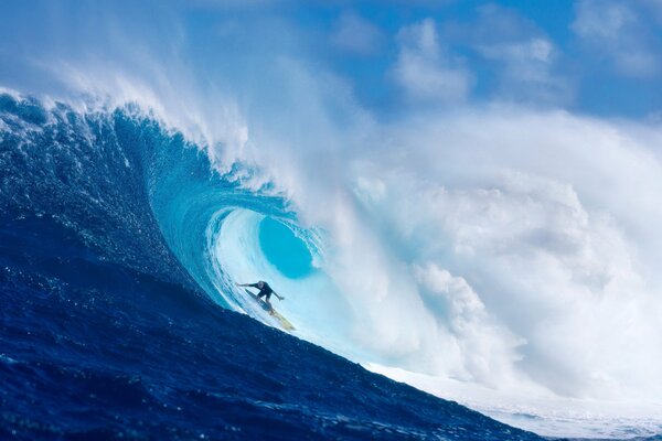 Surfista passa sotto una grande onda