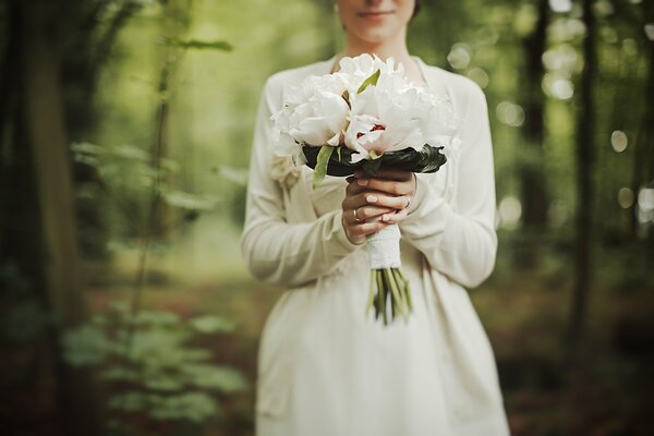 Peonie bianche nel bouquet da sposa della sposa